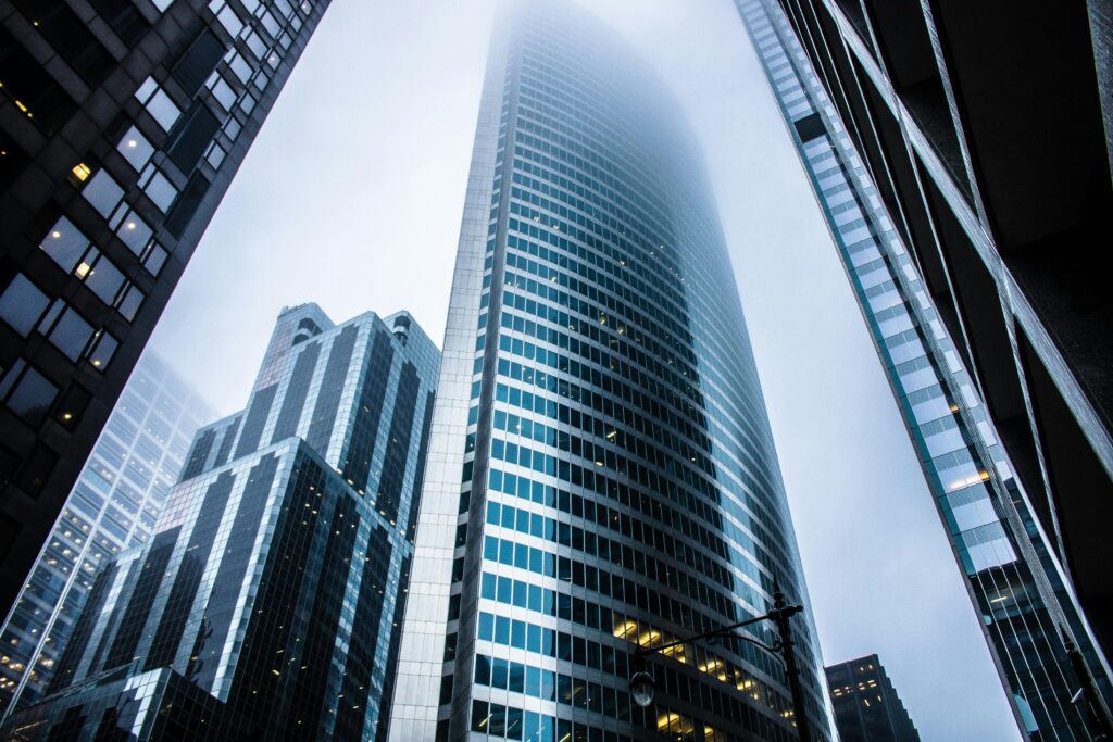 pexels-photo-936722-936722 Dramatic view of modern skyscrapers shrouded in fog in an urban cityscape.